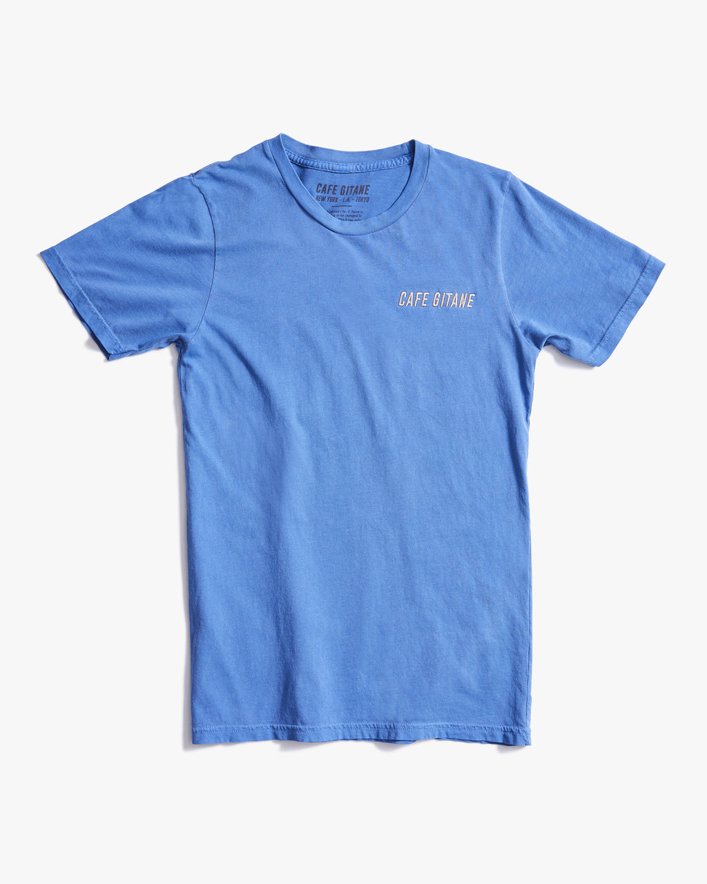 The Cafe Gitane Vintage Wash Embroidered Tee is 100% ring spun cotton and made in the USA. The classic t-shirt in sky blue is embroidered on the left chest in a silver-gray thread. The t-shirt is pigment dyed which means that it has a sublet vintage look and will get more wash the older it gets.