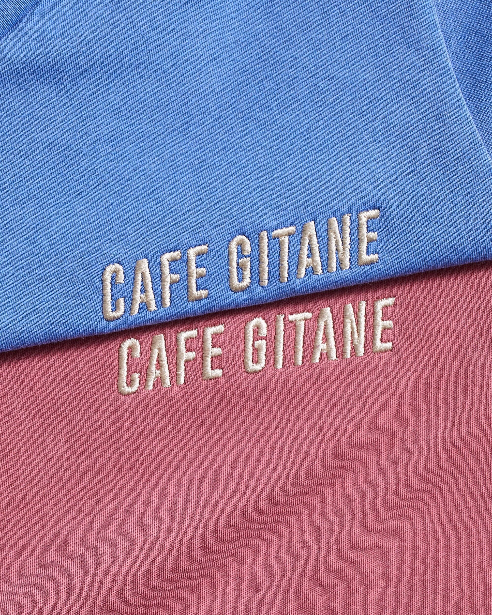 The Cafe Gitane Vintage Wash Embroidered Tee is 100% ring spun cotton and made in the USA. The classic t-shirt is available in red clay and sky blue is embroidered on the left chest in a silver-gray thread. The t-shirt is pigment dyed which means that it has a sublet vintage look and will get more wash the older it gets.